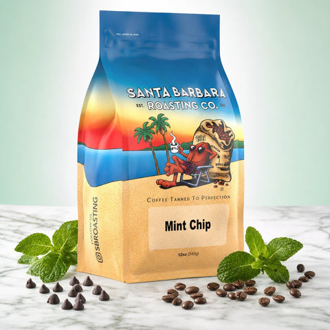 Mint Chip flavored coffee bag with fresh mint leaves and chocolate chips on marble
